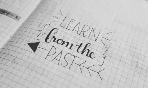 Piękna zmiana pisma w zeszycie: "LEARN from the PAST". Strzałka wskazuje kierunek nauki.
