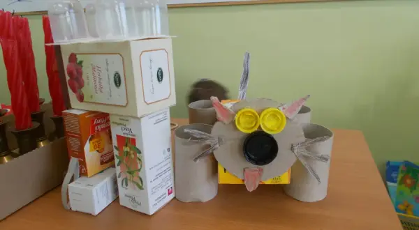 Zabawny robot z recyklingu, zrobiony z pudełek po herbacie i rolki po papierze toaletowym. Idealny przykład, jak zrobić robota z recyklingu.