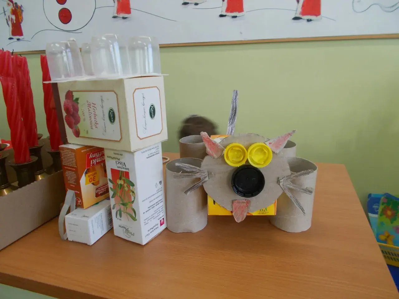 Zabawny robot z recyklingu, zrobiony z pudełek po herbacie i rolki po papierze toaletowym. Idealny przykład, jak zrobić robota z recyklingu.